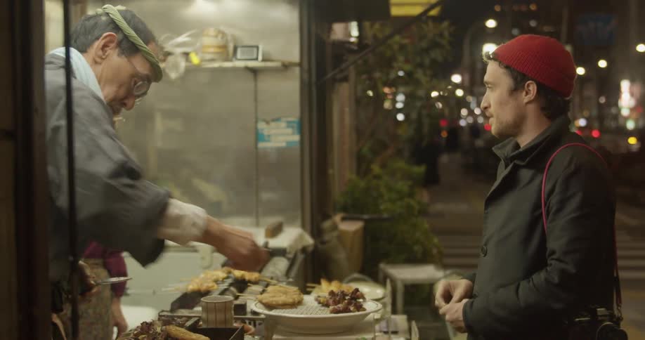 A white male orders a meal from an asian walk up restaurant