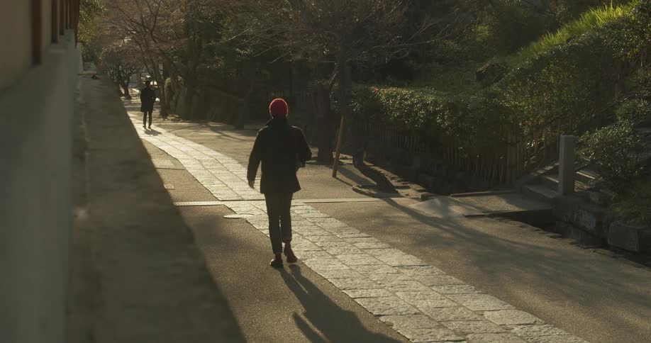 People walk on the sidewalk