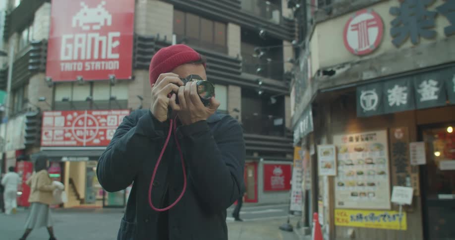 Photographer standing in street takes pictures