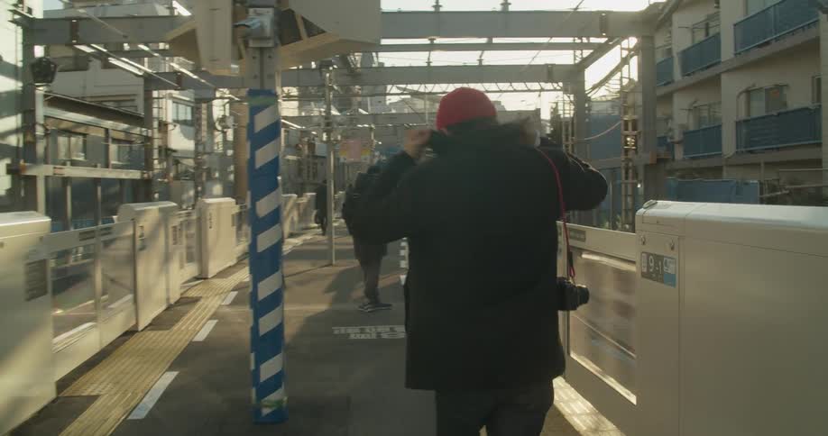 A man walking on a train station platform