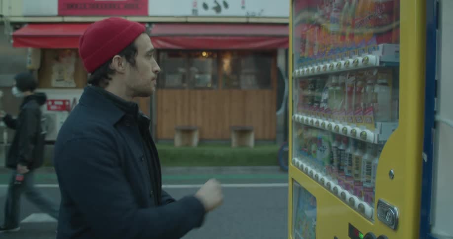 A man buying a drink from a vending machine