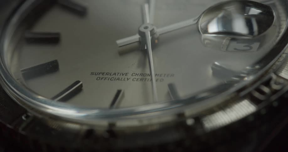 Light moving across face of watch as second hand moves clockwise