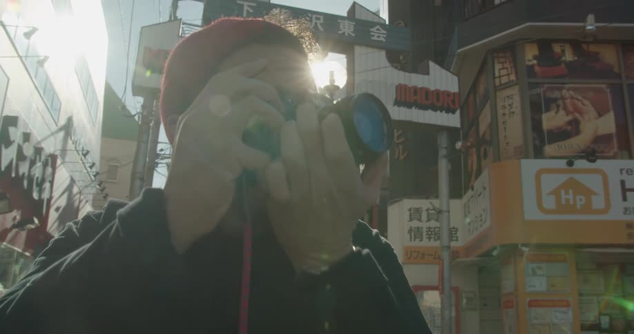 A tourist takes photographs in the city