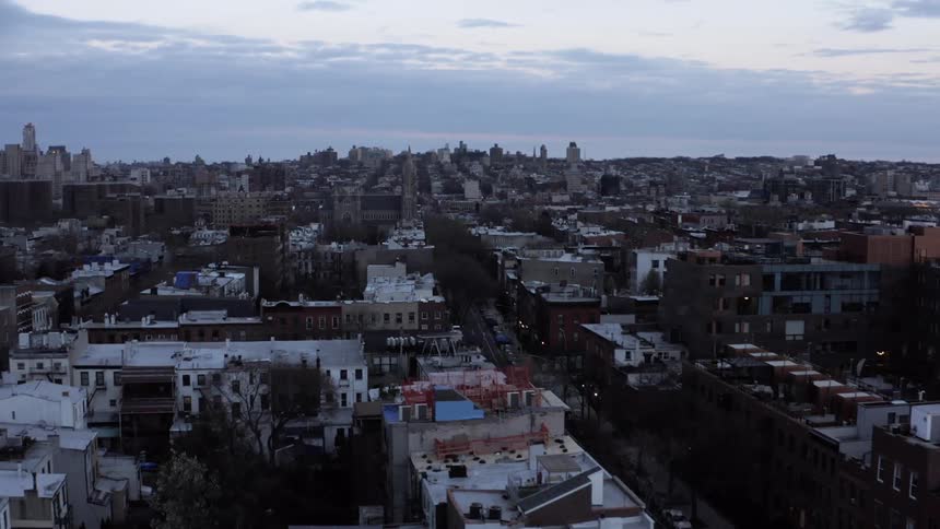 A city is visible on a cloudy day