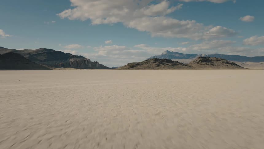 A desert with hills in the background