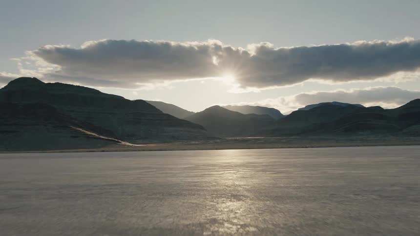 Aerial drone view of a dry lakebed at sunset