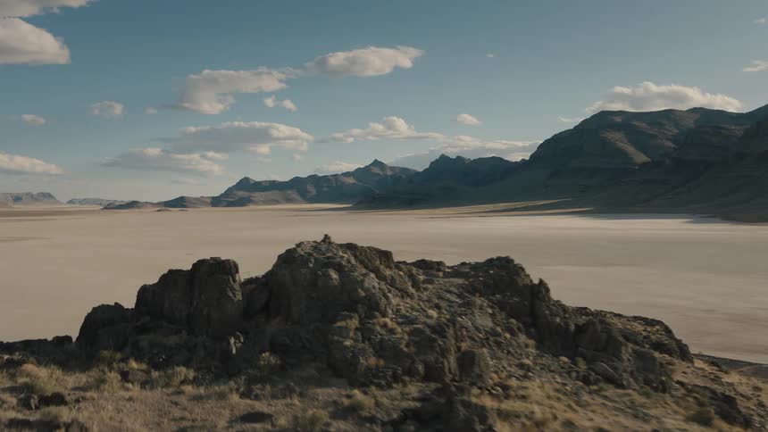 A desert surrounded by a mountain range