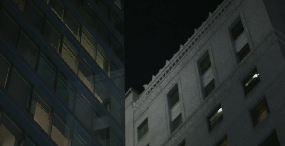 Apartment buildings sit in the city at night