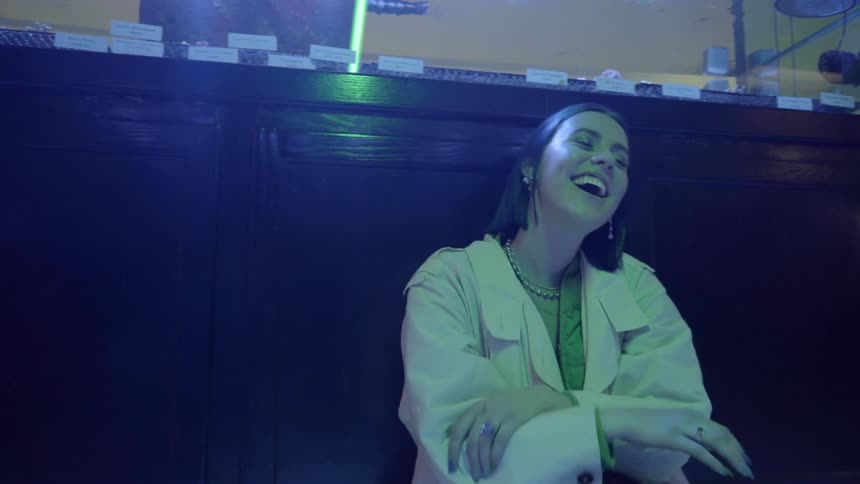 A woman sits on a bench and laughs