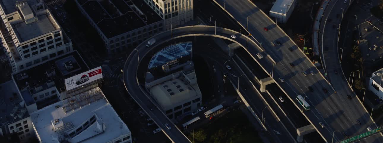 Traffic flows down a freeway through an urban area