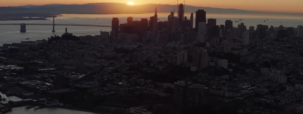 The city is dark at sunset