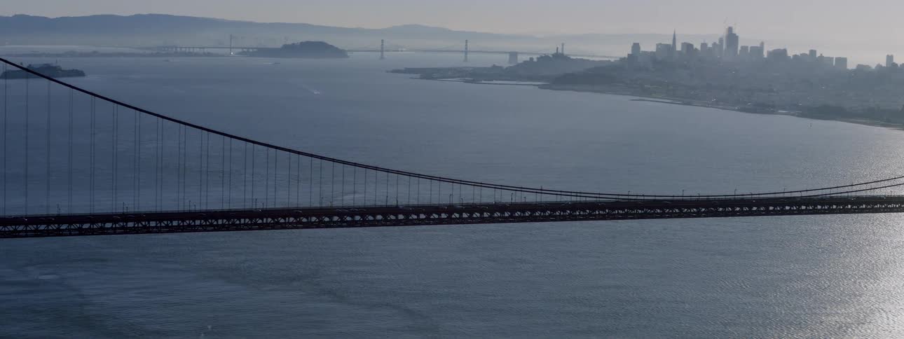 The sun rises over the golden gate bridge