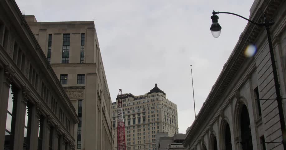 City buildings sit under a cloudy sky