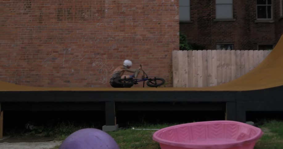 Bicyclist performs trick on slope and falls