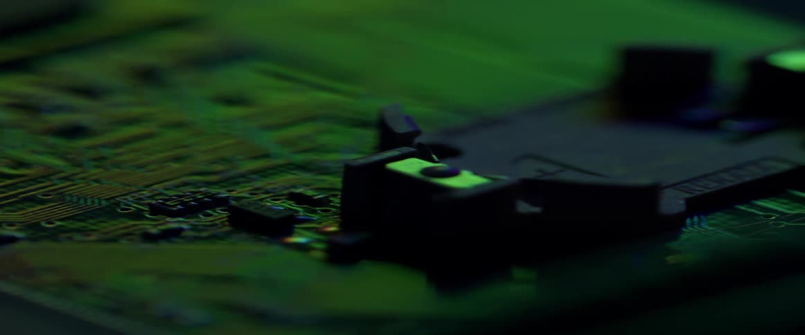 Blue and green light glows on a circuit board