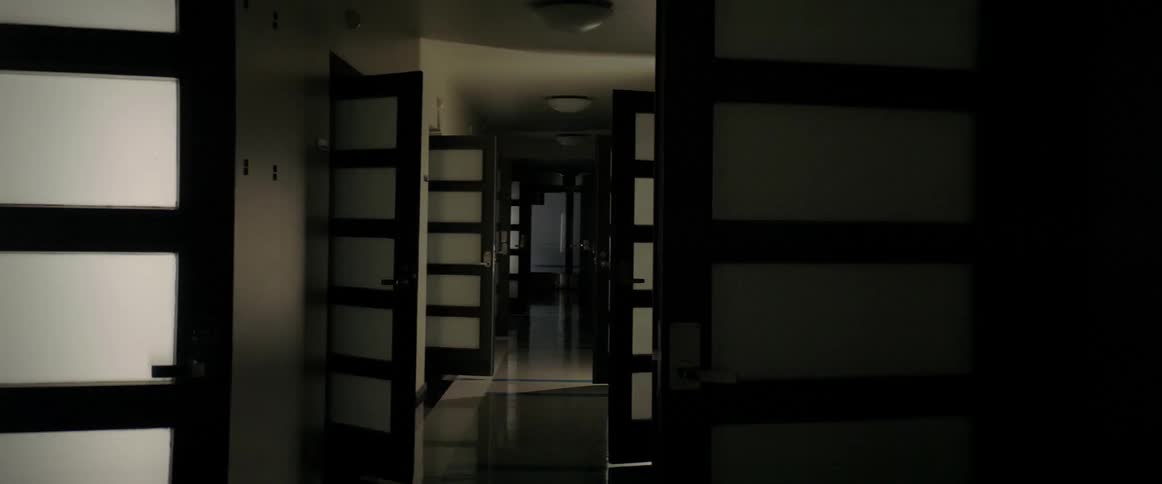 Lights flashing in a hallway with open doors