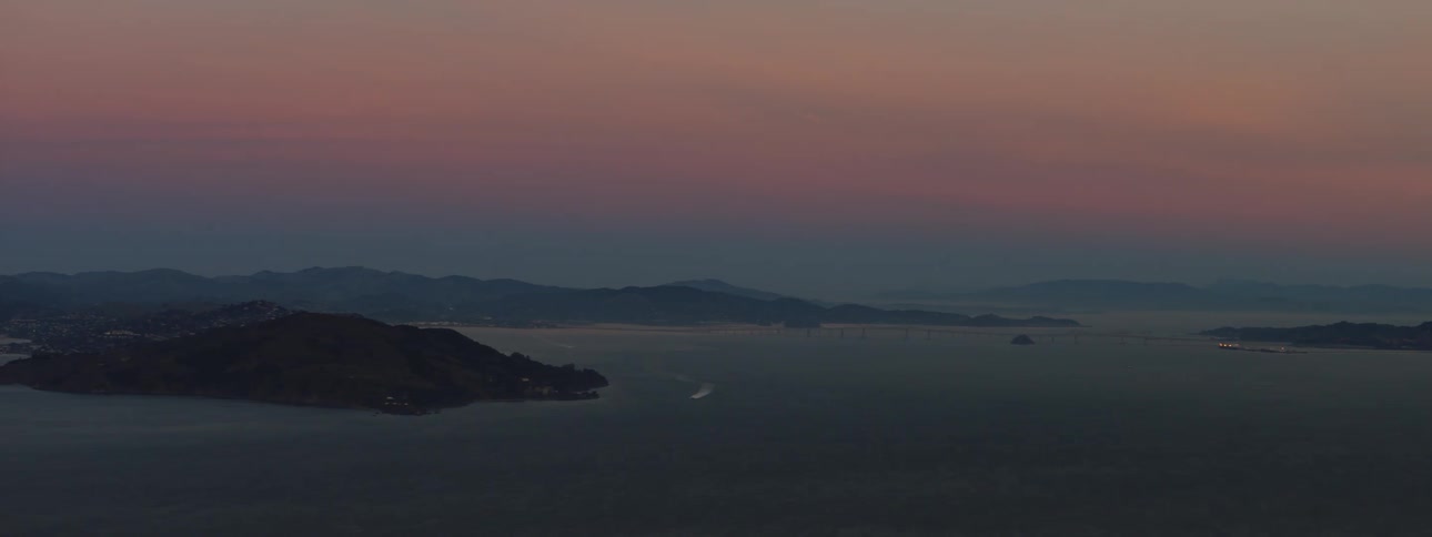 A large body of water with an island and the coast in view