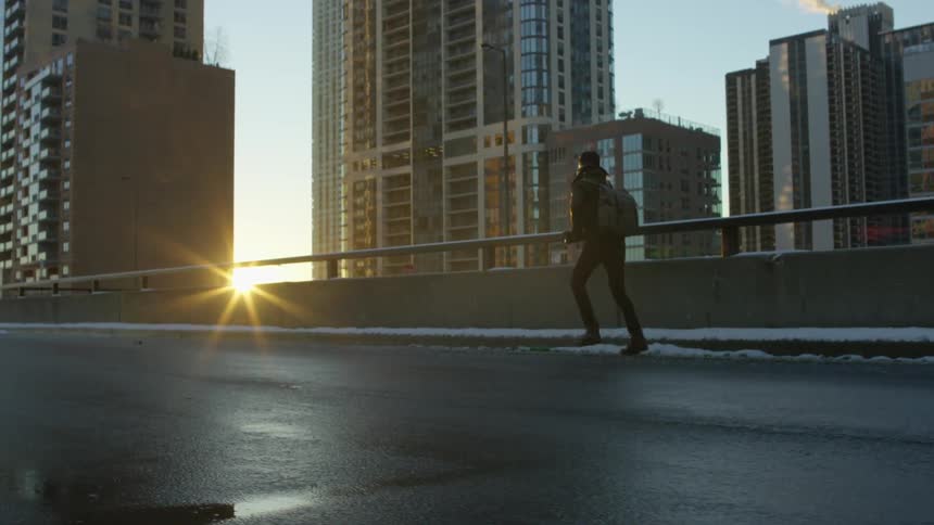A man running on an urban bridge