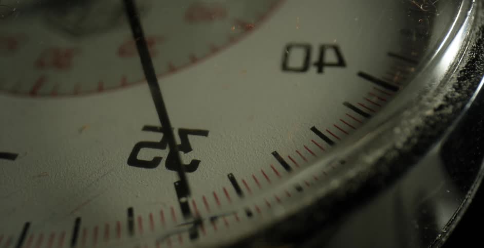 A hand moves on a timepiece