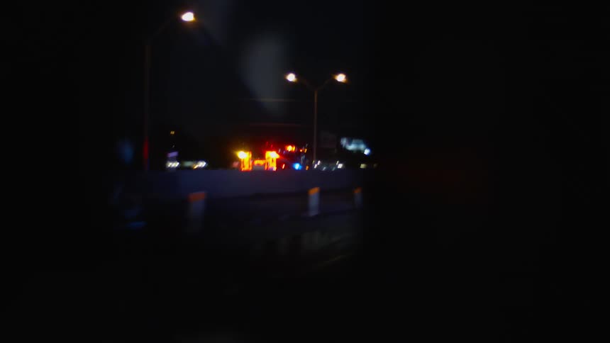 A fire truck races down a highway with lights flashing