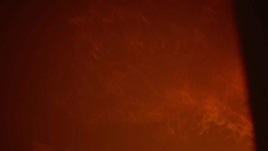 Flames billow from a building at night