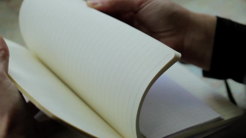 A man flips through a notebook