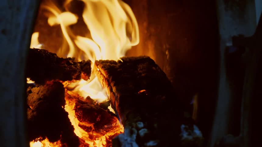 View of a burning fireplace with crackling fire