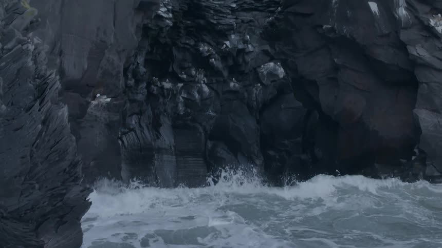 Water crashes against rocks in this large cavern