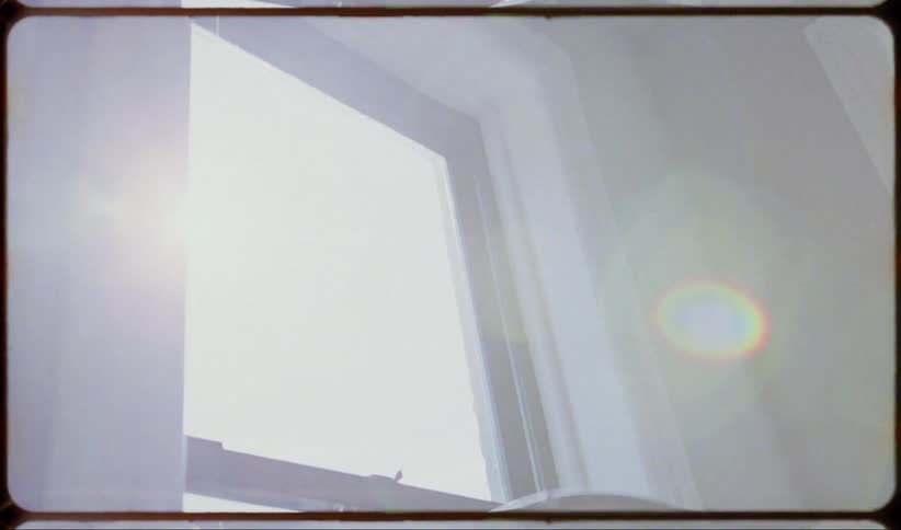 An apartment window with a fan
