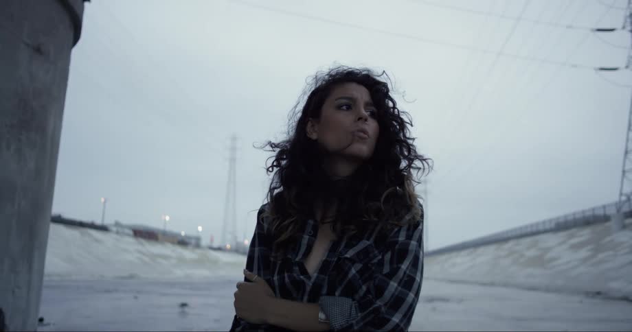 Portrait of a young woman under an overcast sky