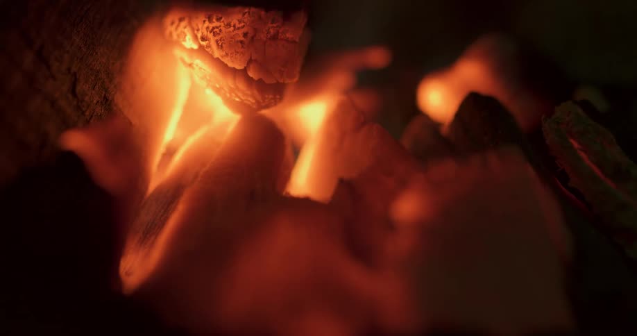 Flames raise from burning coals