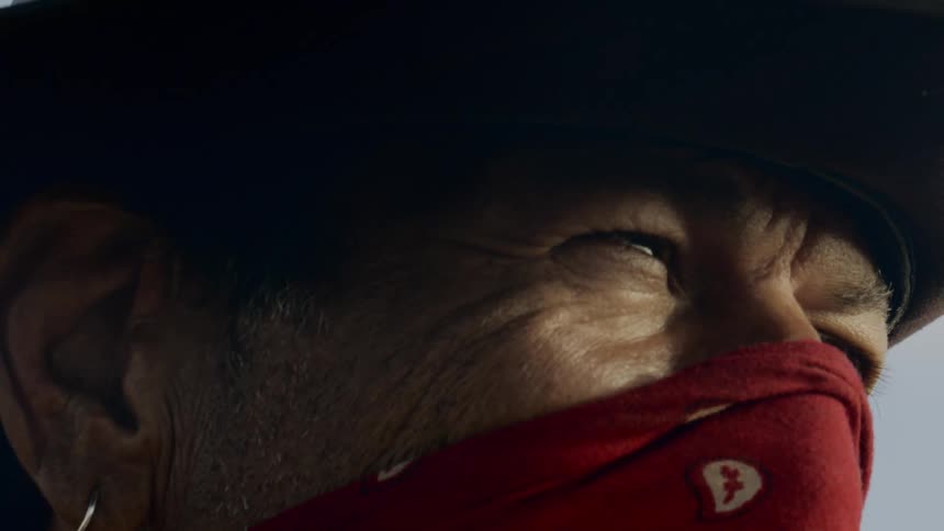 Side view of a cowboy wearing a red bandana