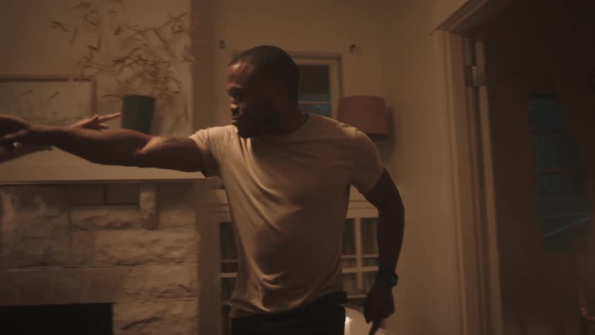Black man and woman dance in the living room at home