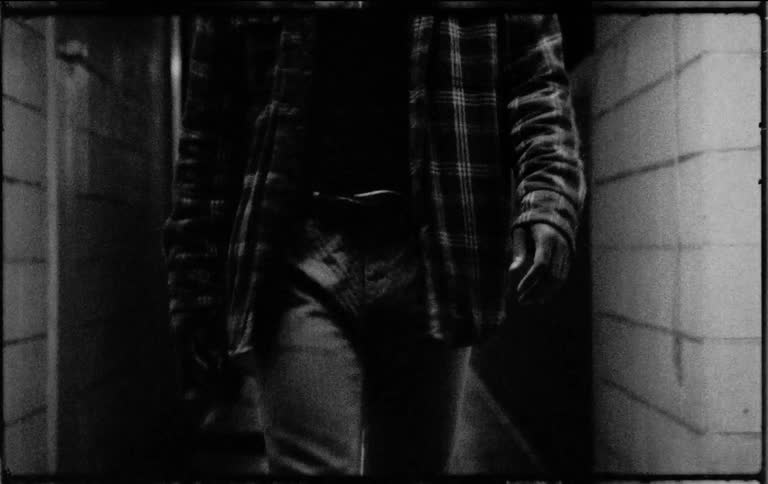 A man walks down a hallway