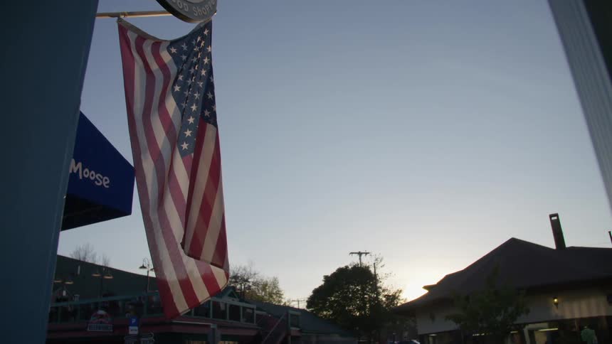 The american flag flutters in the breeze at dusk
