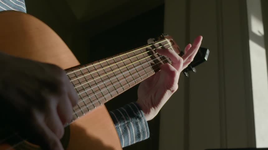 A person plays guitar
