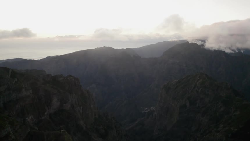 Low clouds hang over a large mountain range