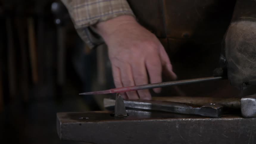 A man is using tools in a work environment