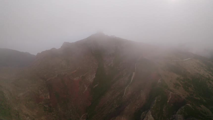 Thick fog flowing over a mountain