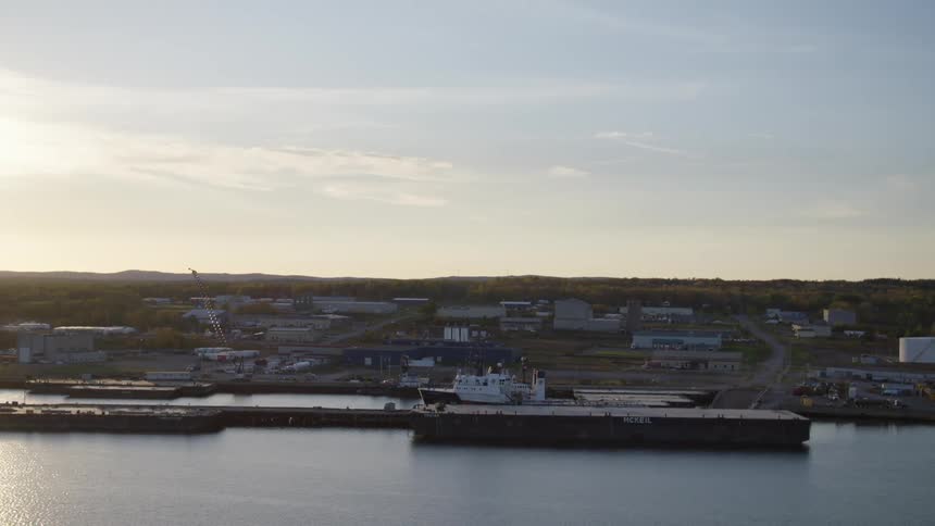 A harbor with a boat and buildings in the background
