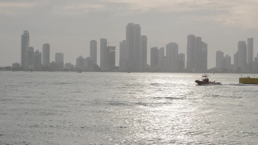 Boat sailing on the sea in front of city skyline
