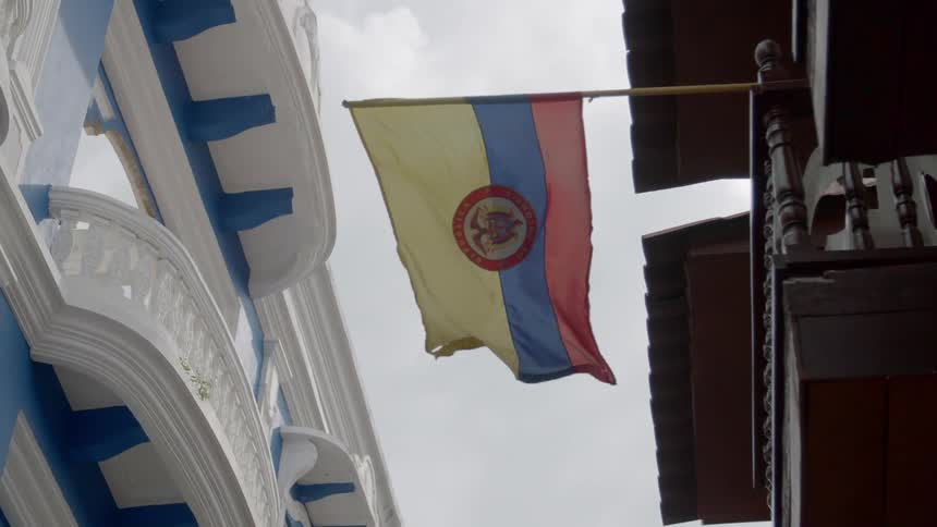A flag hanging on the side of a building