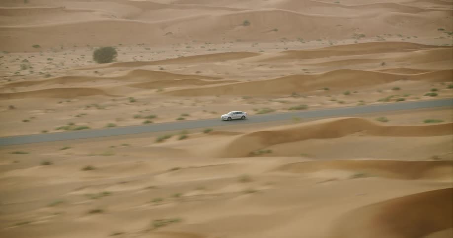 The car drives down the road