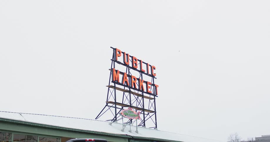 A building with a sign with the sky in the background