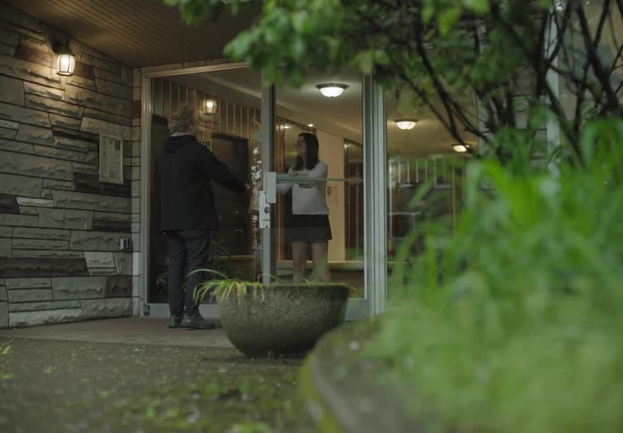 A man delivers food to a woman