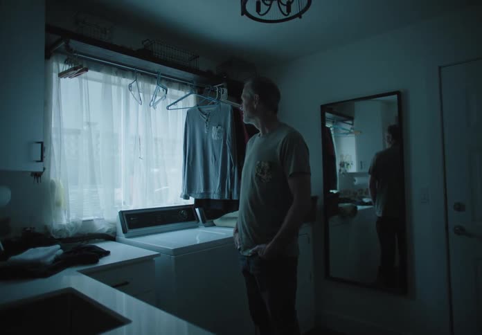 A man is standing in a room alone