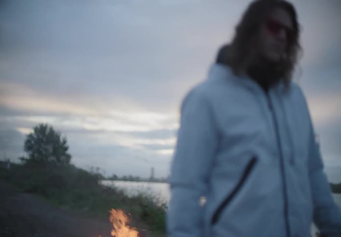 Man throws gas on a fire