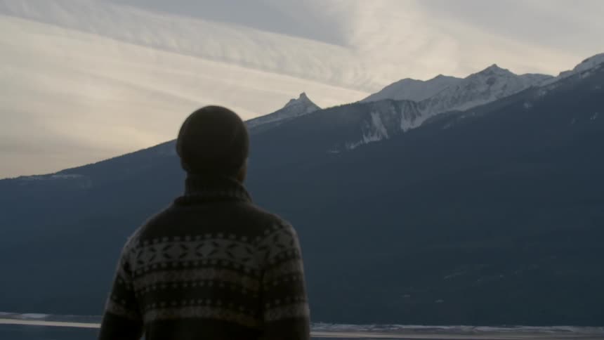 A man looks at a mountain