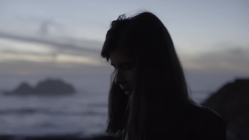 A woman walking near the ocean