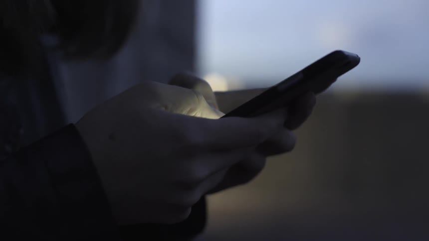 A person types on a smartphone